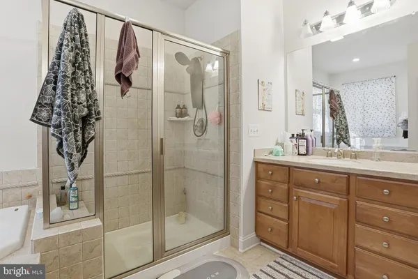 a bathroom with a shower and a sink mirror