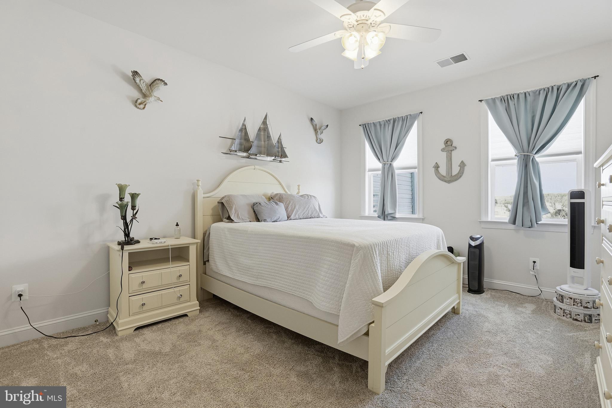 40 Branson Cove Road Hague, VA 22469 - Photo 27 of 51 a bedroom with a bed and a chandelier