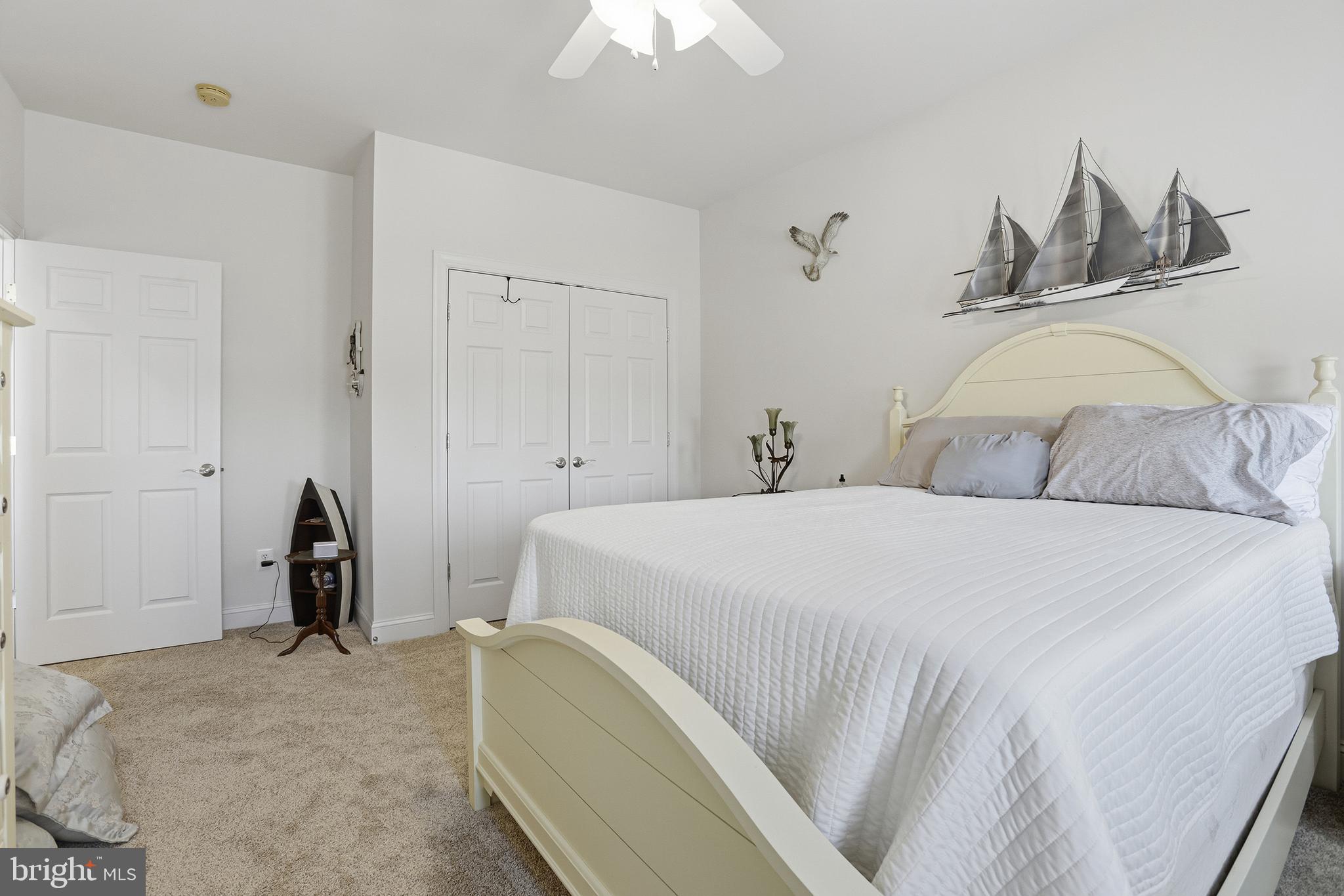 40 Branson Cove Road Hague, VA 22469 - Photo 28 of 51 a bedroom with a bed and a chandelier