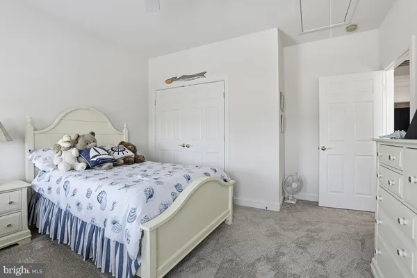a bedroom with a bed and a dresser in it