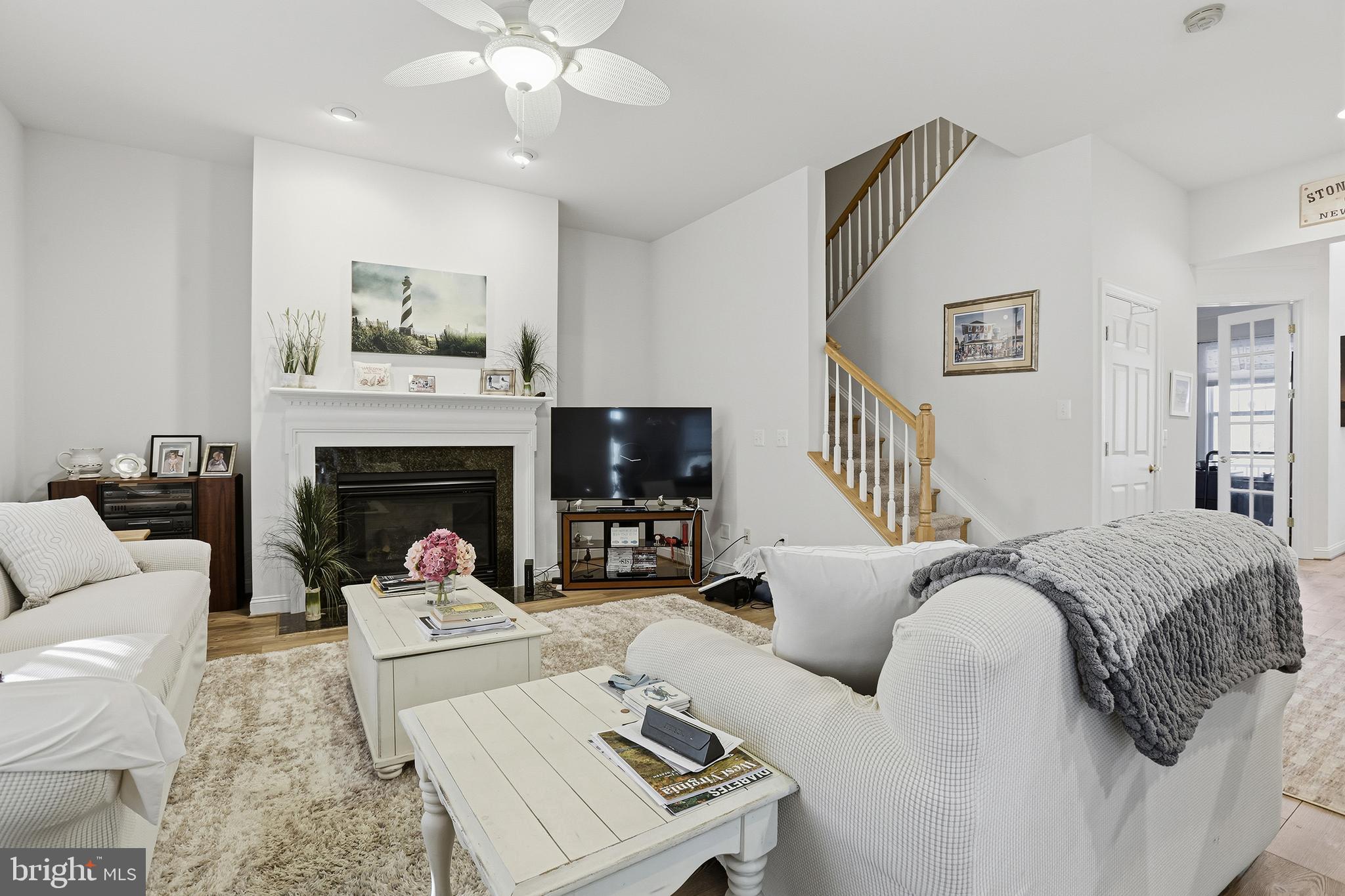 40 Branson Cove Road Hague, VA 22469 - Photo 10 of 51 a living room with furniture a fireplace and a flat screen tv