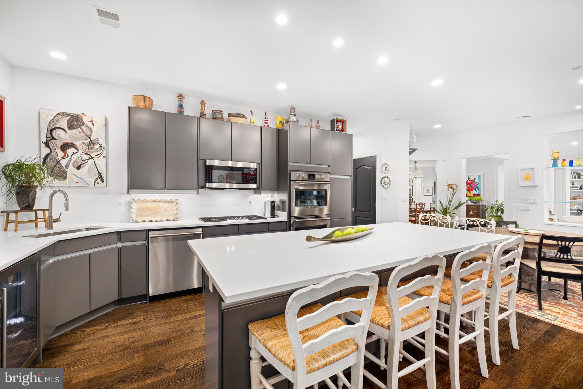 7222 47th Street, Unit R2 Bethesda, MD 20815 - Photo 12 of 26 a kitchen with stainless steel appliances granite countertop a kitchen island a stove a table and chairs
