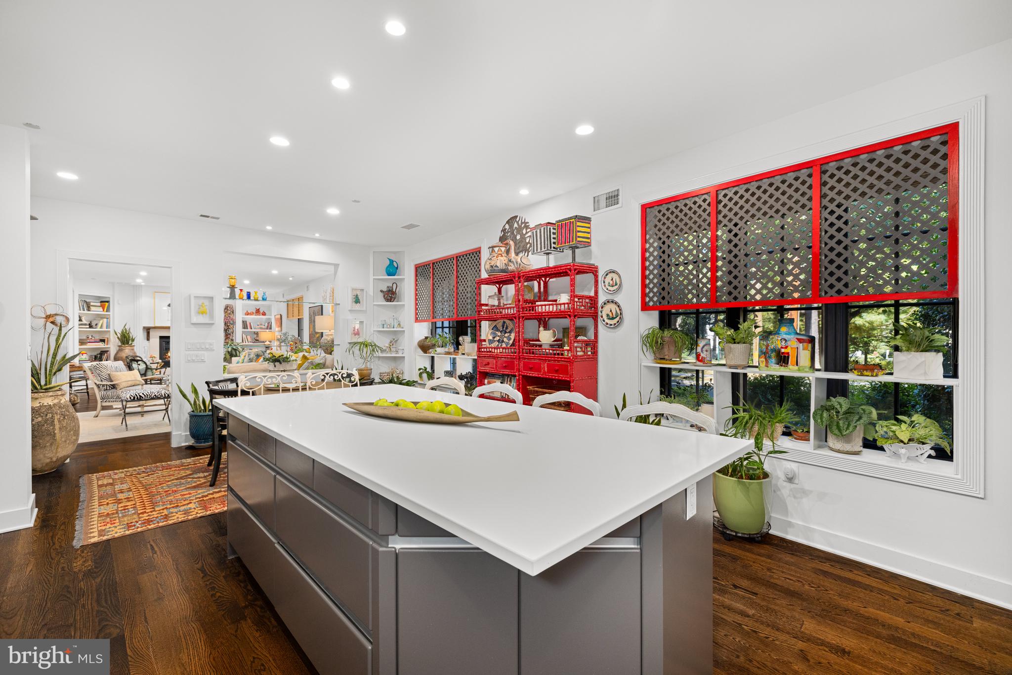 7222 47th Street, Unit R2 Bethesda, MD 20815 - Photo 13 of 26 a view of kitchen island with stainless steel appliances kitchen island granite countertop a dining table and chairs with wooden floor