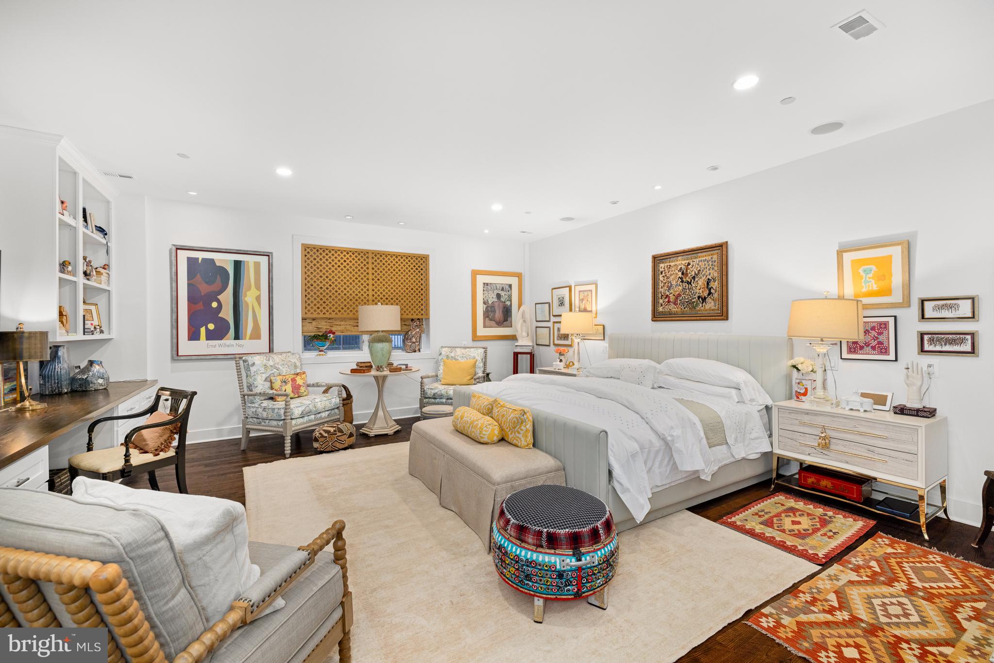 7222 47th Street, Unit R2 Bethesda, MD 20815 - Photo 16 of 26 a spacious bedroom with a bed a couch and cabinet