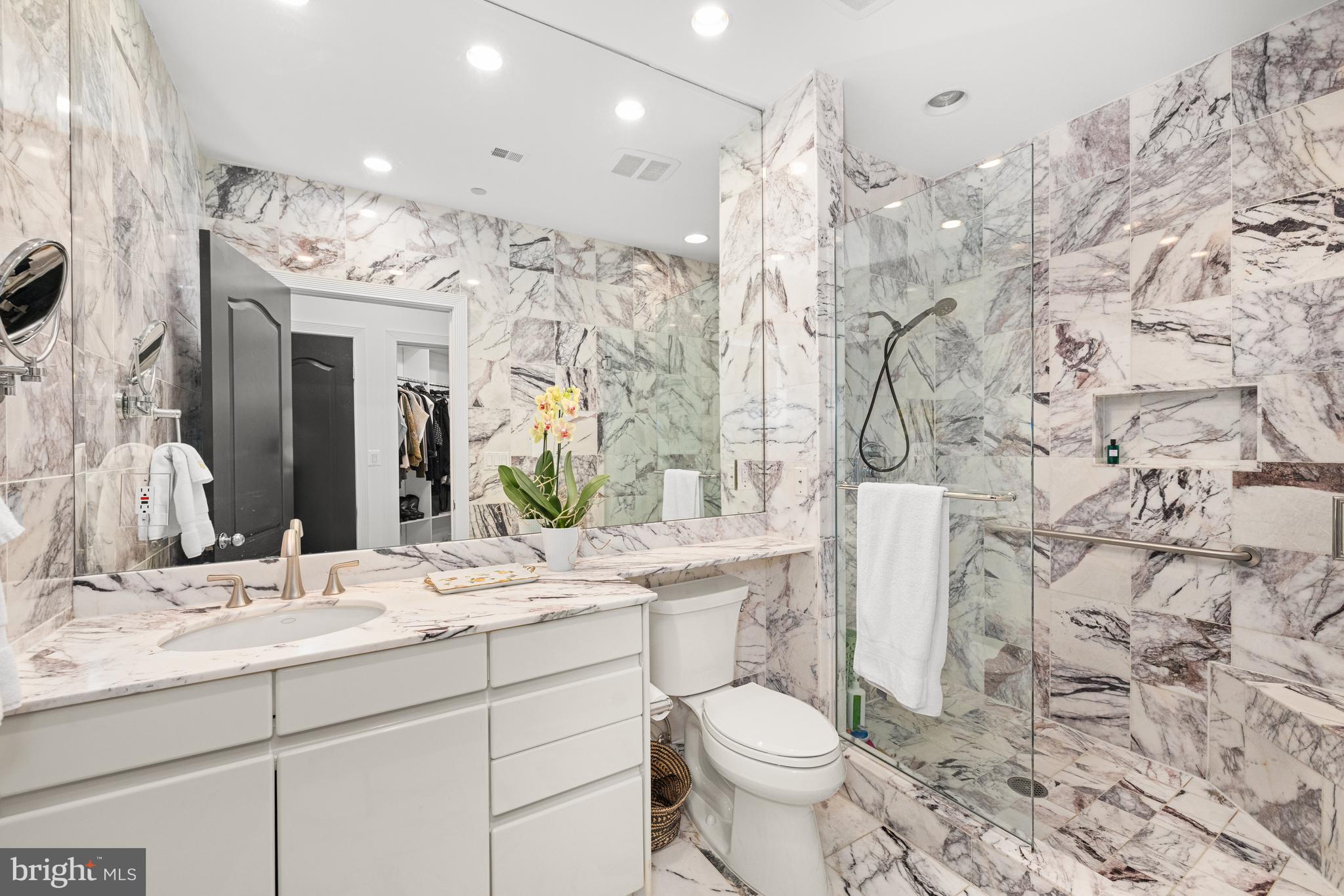 7222 47th Street, Unit R2 Bethesda, MD 20815 - Photo 19 of 26 a bathroom with a toilet sink and mirror