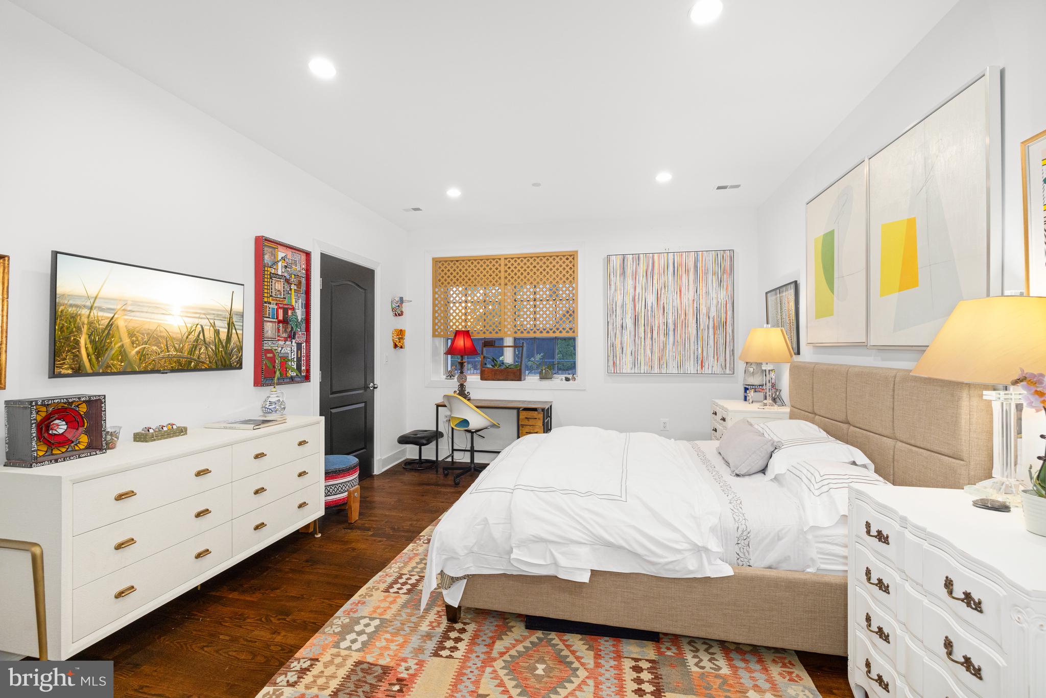 7222 47th Street, Unit R2 Bethesda, MD 20815 - Photo 21 of 26 a bedroom with a bed a flat screen tv and dresser in it