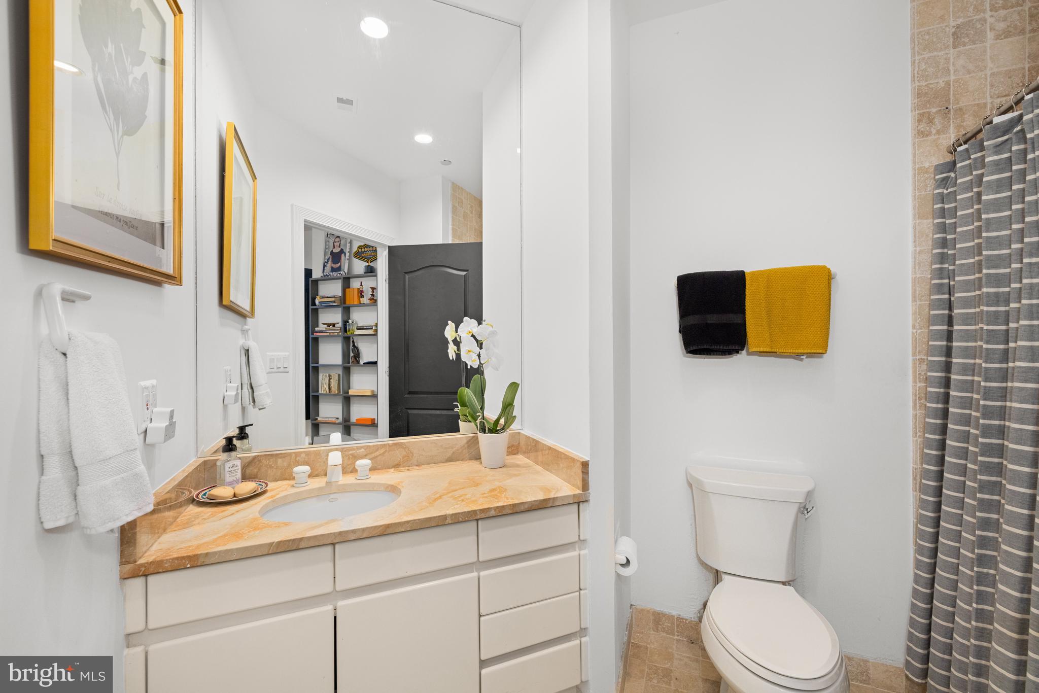 7222 47th Street, Unit R2 Bethesda, MD 20815 - Photo 22 of 26 a bathroom with a toilet sink and mirror