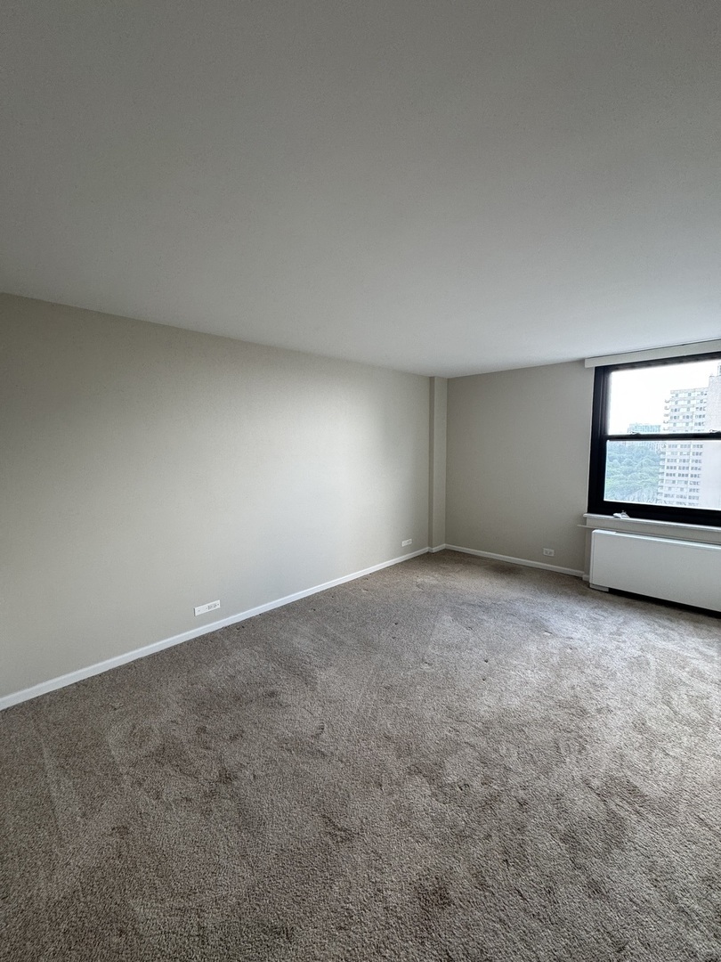 5701 North Sheridan Road, Unit 17S Chicago, IL 60660 - Photo 5 of 8 a view of an empty room with a window