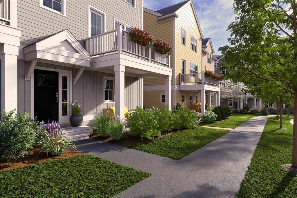 643 Church Street, Unit 122 Raynham, MA 02767 - Photo 23 of 28 a view of a white house next to a yard and plants