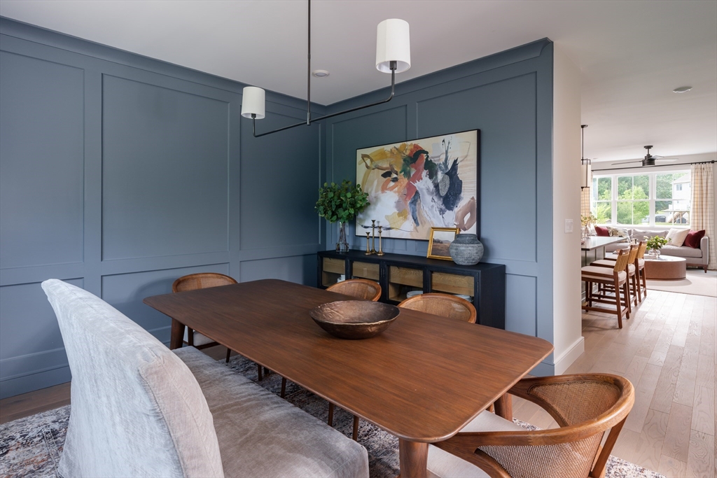 643 Church Street, Unit 122 Raynham, MA 02767 - Photo 5 of 28 a dining room with furniture and wooden floor