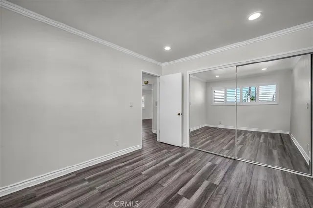 a view of wooden floor and windows in a room