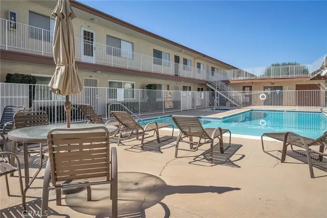 a view of a patio with table and chairs with wooden floor and fence