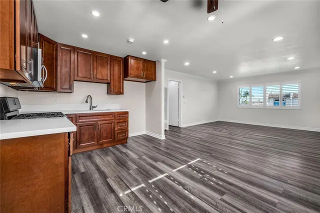 a kitchen with stainless steel appliances wooden cabinets and a stove top oven