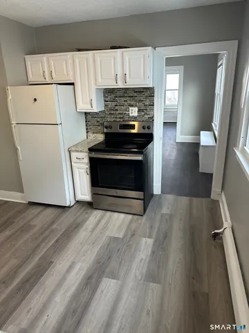 a kitchen with a refrigerator and a stove