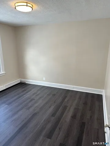 a view of a room with wooden floor