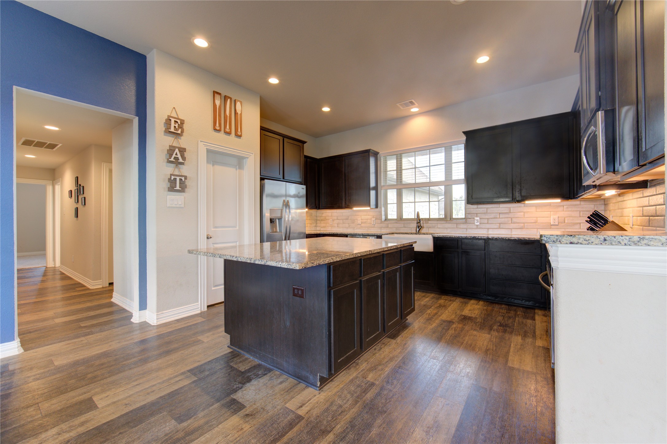 203 Lily Lane Rosharon, TX 77583 - Photo 12 of 50 a kitchen with stainless steel appliances granite countertop a stove a sink and a refrigerator