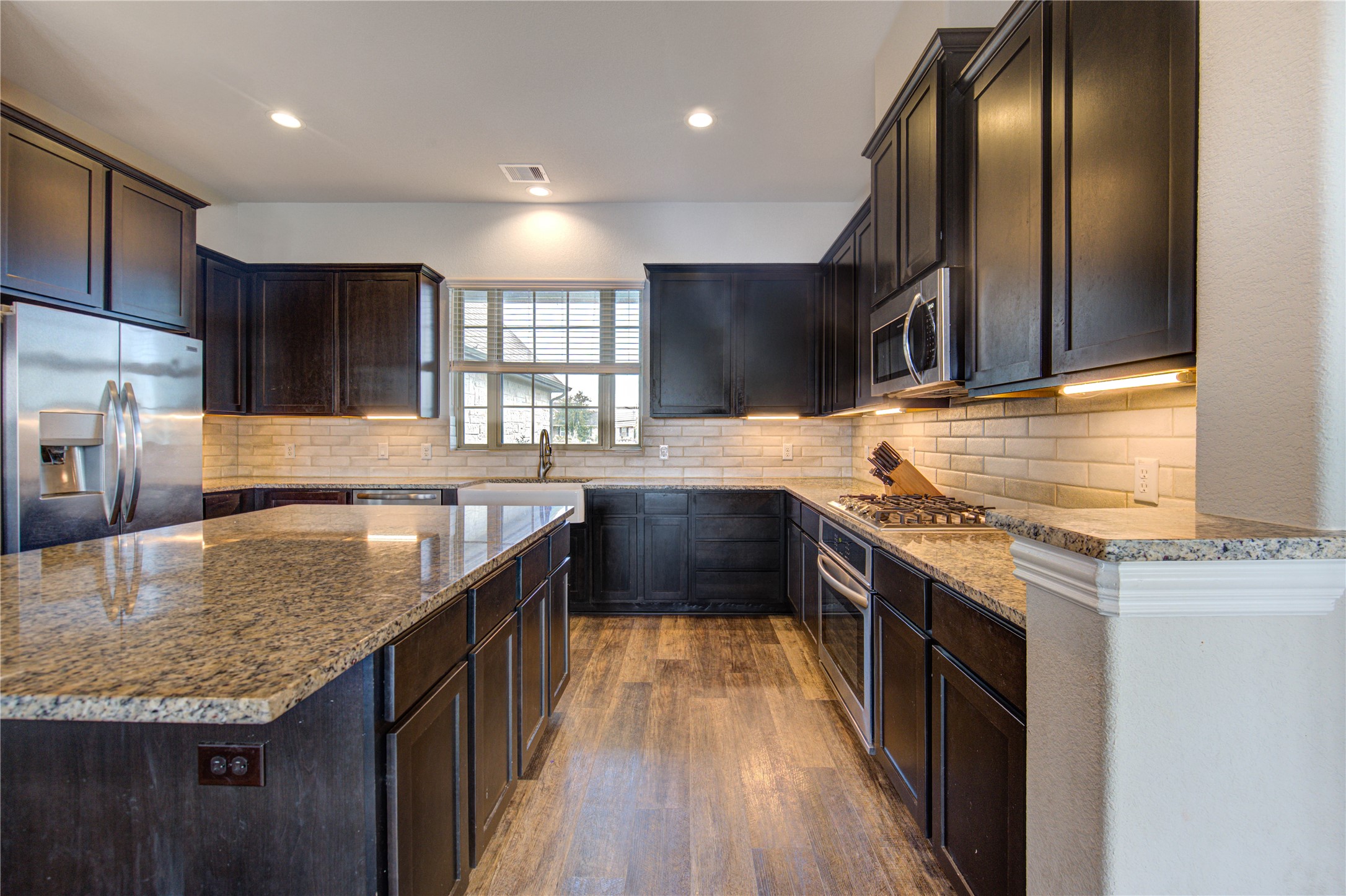203 Lily Lane Rosharon, TX 77583 - Photo 13 of 50 a kitchen with stainless steel appliances granite countertop a sink stove and refrigerator