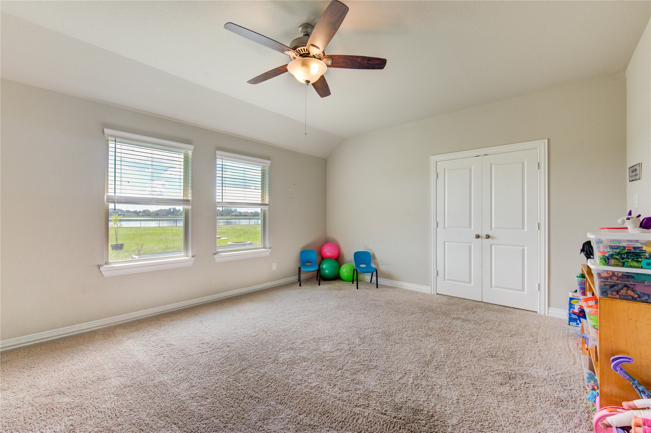 203 Lily Lane Rosharon, TX 77583 - Photo 23 of 50 a view of an empty room with a window and a ceiling fan