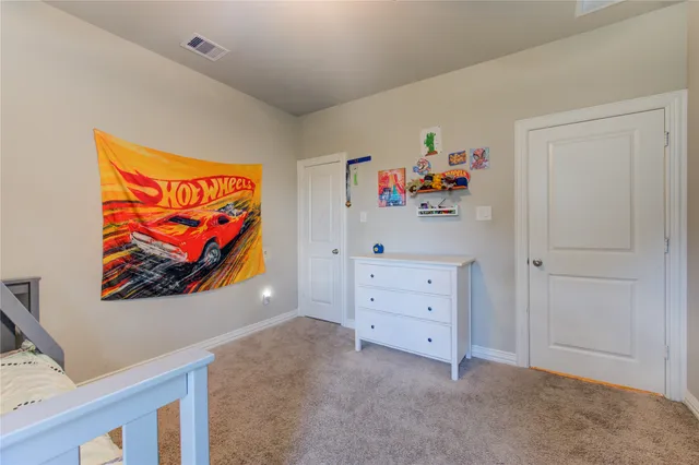 an entryway with painting on the wall and a window