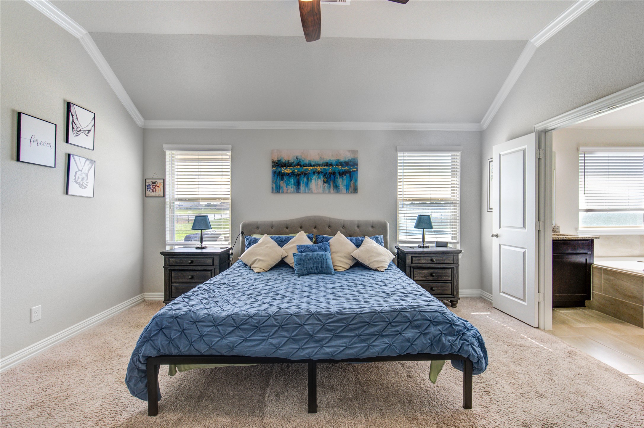 203 Lily Lane Rosharon, TX 77583 - Photo 29 of 50 a large bedroom with a large bed a rug and painting on the wall