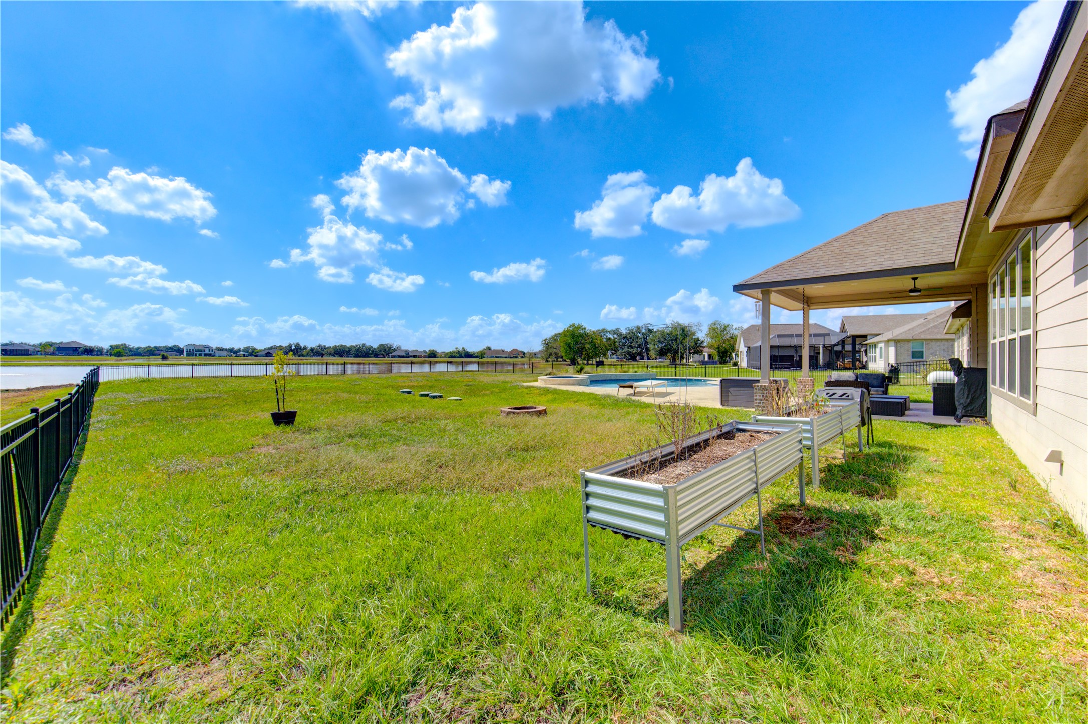 203 Lily Lane Rosharon, TX 77583 - Photo 40 of 50 a view of a swimming pool with a yard