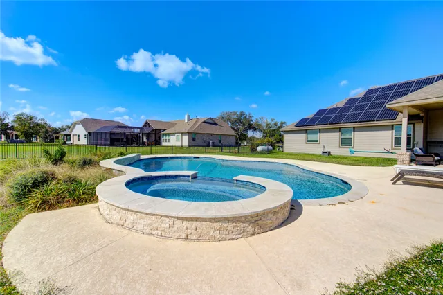 a view of a swimming pool with a yard