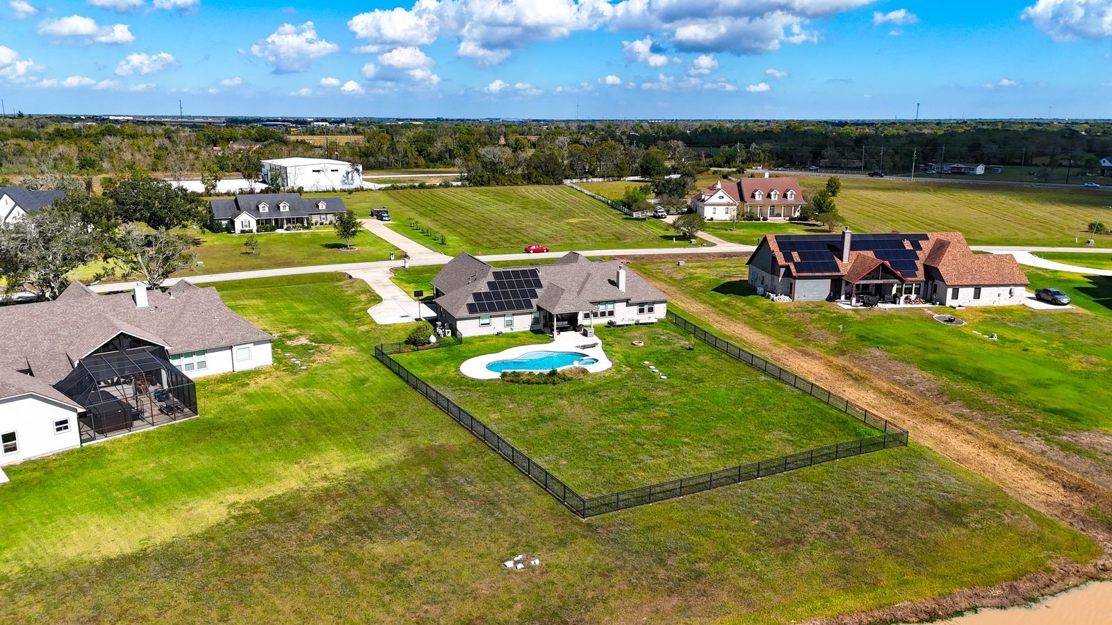 203 Lily Lane Rosharon, TX 77583 - Photo 50 of 50 a view of a swimming pool with a table and chairs under an umbrella