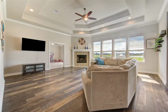 a living room with furniture a fireplace and a flat screen tv
