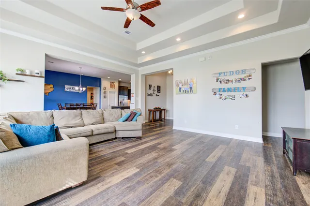 a living room with furniture and a ceiling fan