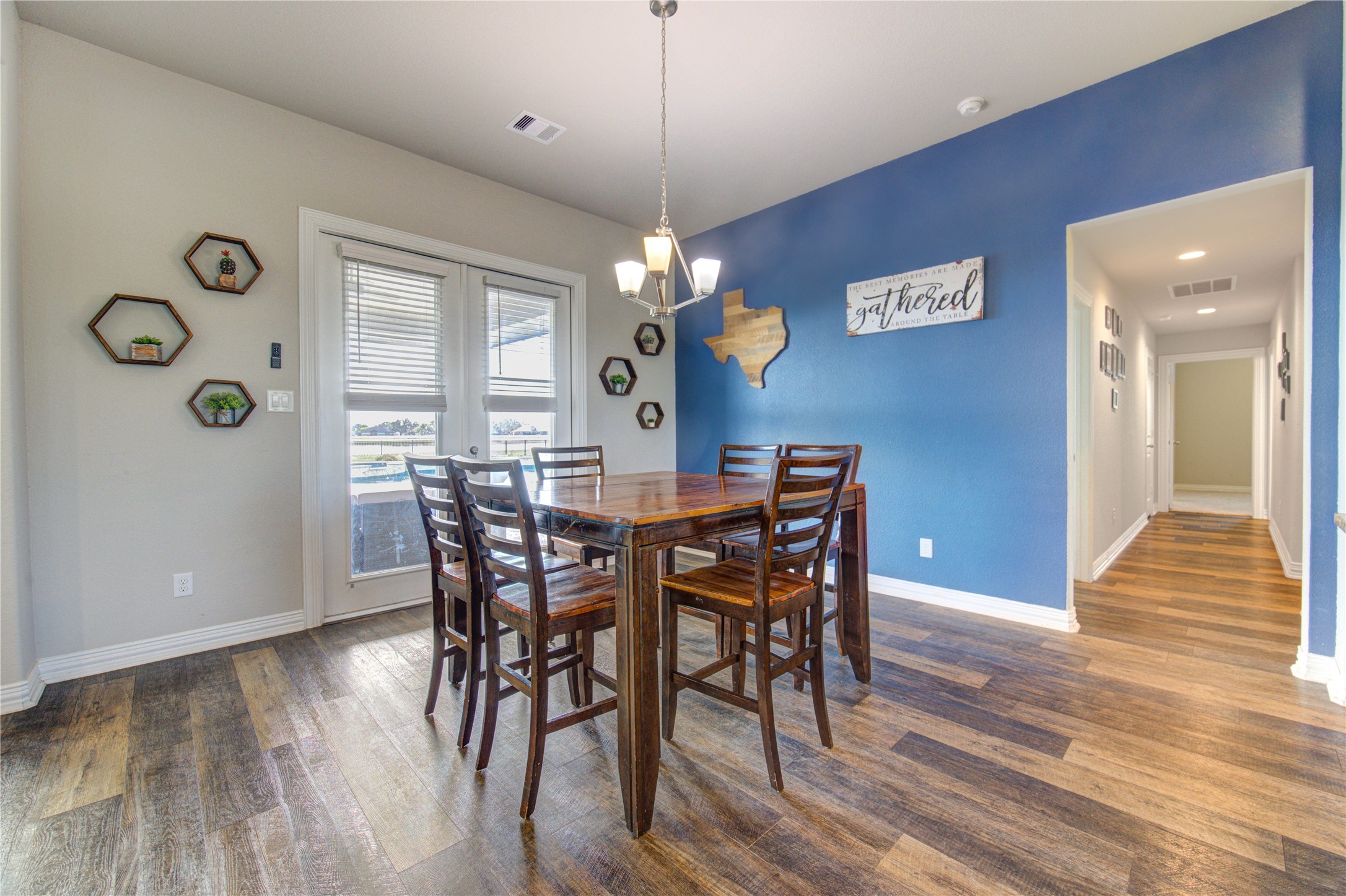 203 Lily Lane Rosharon, TX 77583 - Photo 10 of 50 a view of a dining room with furniture and wooden floor