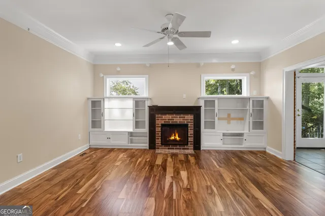wooden floor in an empty room with a fireplace