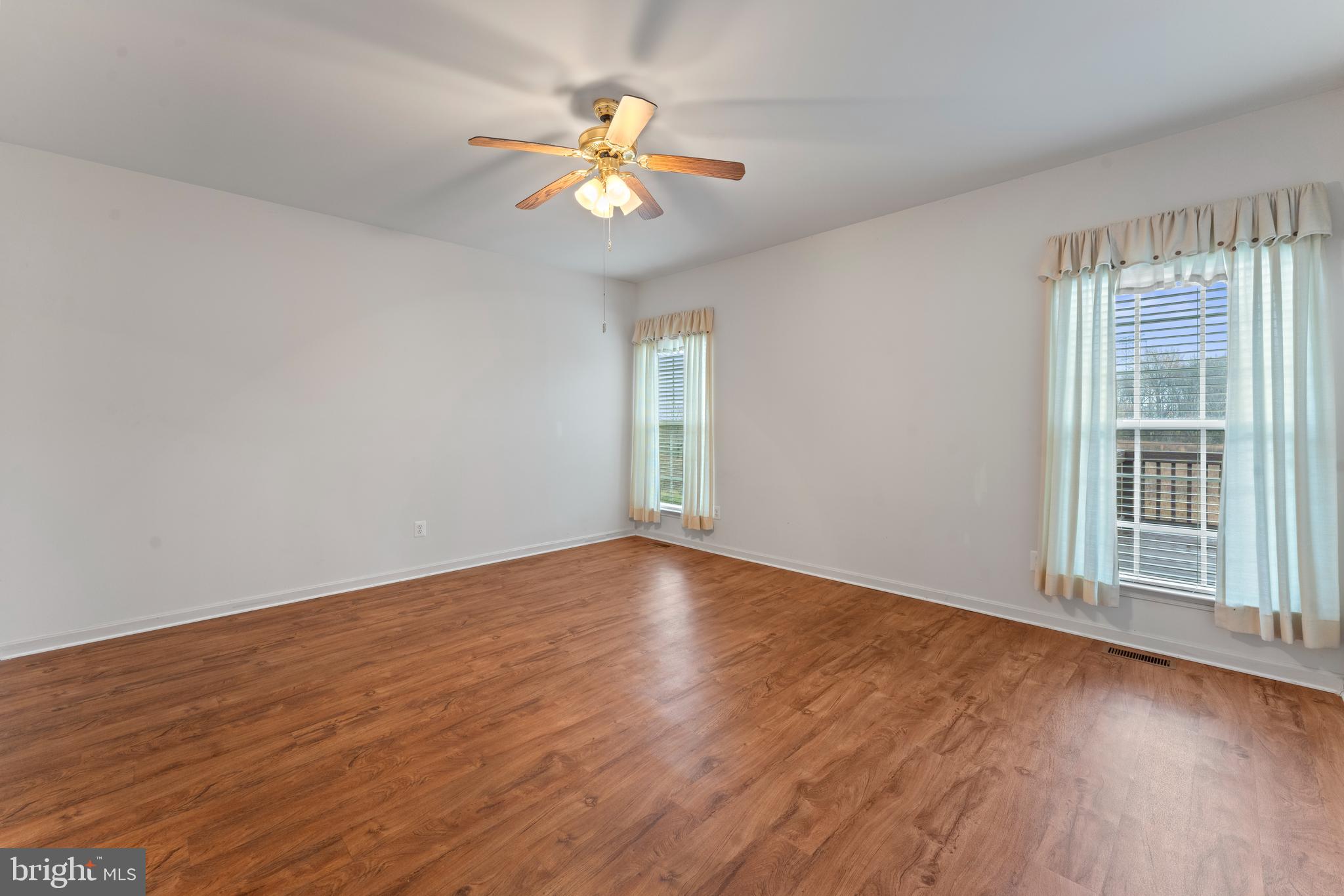 361 Pierce Run Newark, DE 19702 - Photo 12 of 32 a view of an empty room with wooden floor and a window
