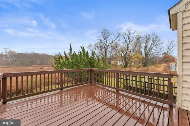a view of balcony with wooden floor and fence
