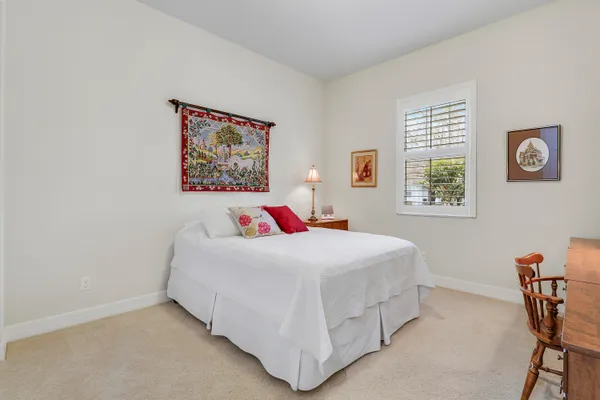 a bedroom with a bed and a desk
