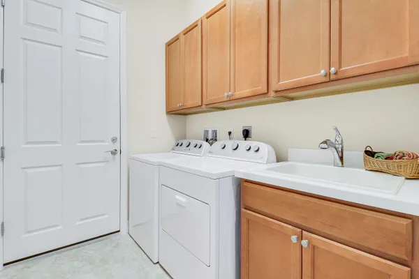 a utility room with sink dryer and washer