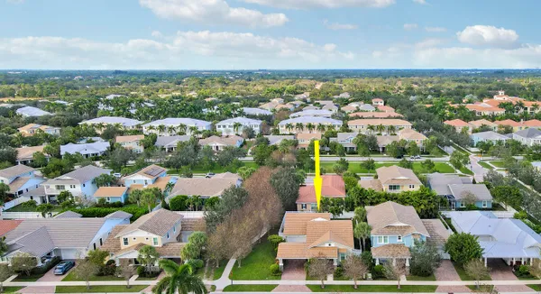 an aerial view of residential houses with outdoor space and swimming pool