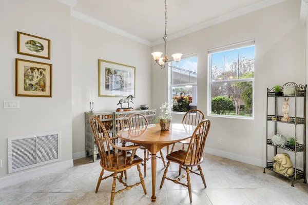 a view of a dining room with furniture window and outside view