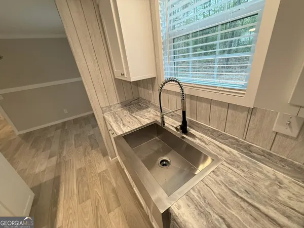 a kitchen with kitchen island a sink stainless steel appliances and window