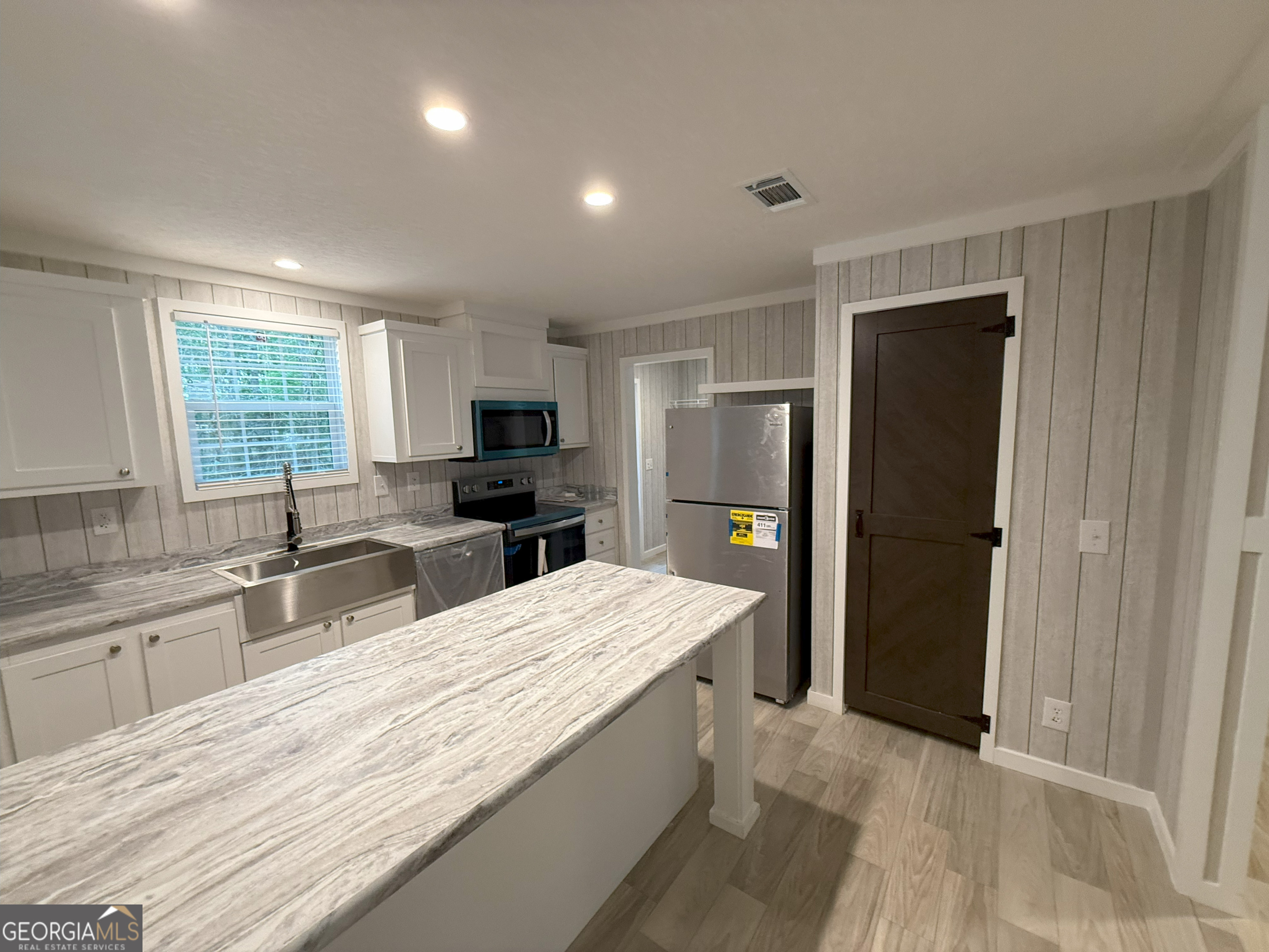 2126 Amberly Road Elberton, GA 30635 - Photo 16 of 68 a large kitchen with a center island and stainless steel appliances