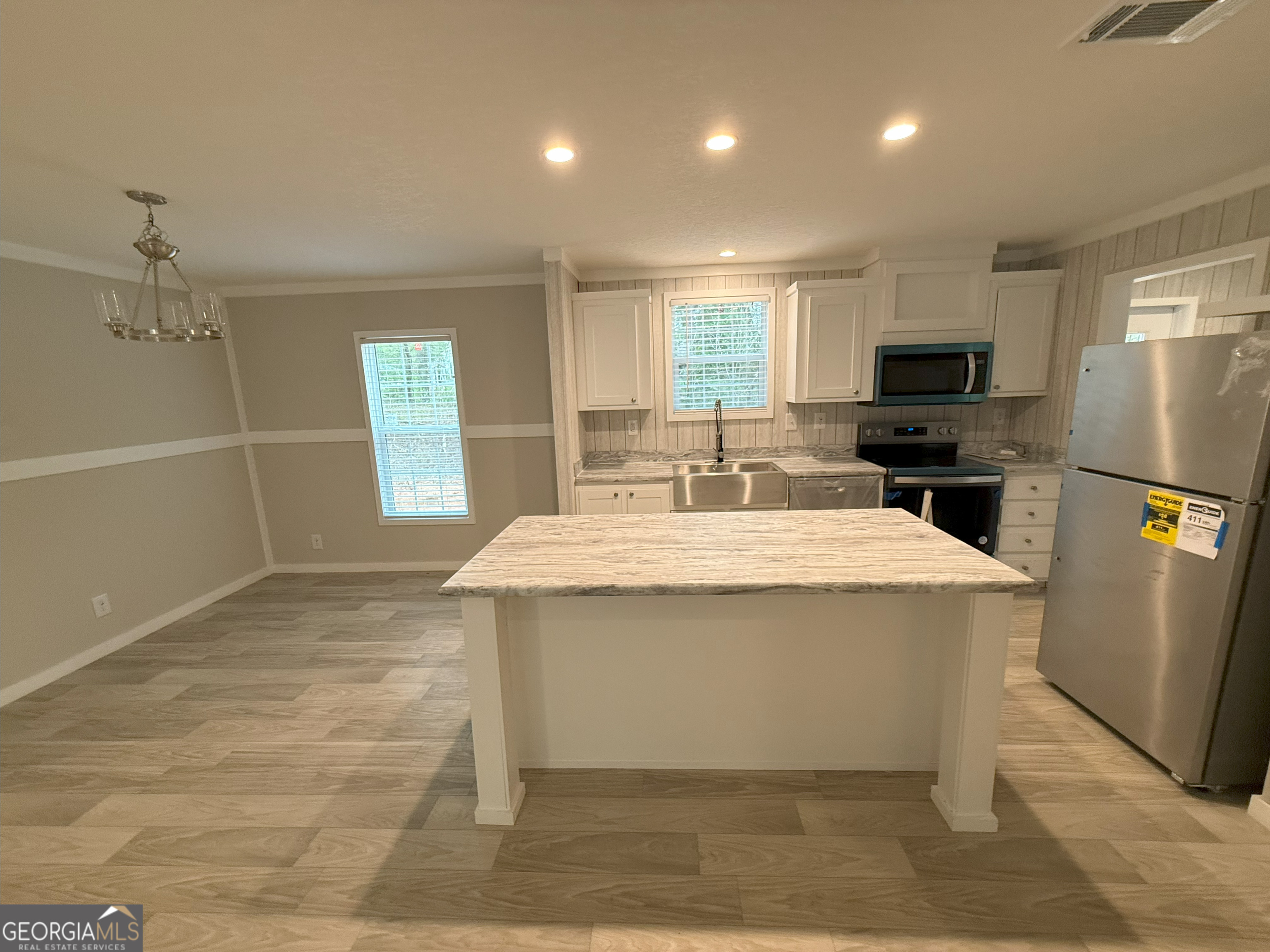 2126 Amberly Road Elberton, GA 30635 - Photo 19 of 68 a kitchen with kitchen island a sink stainless steel appliances and window