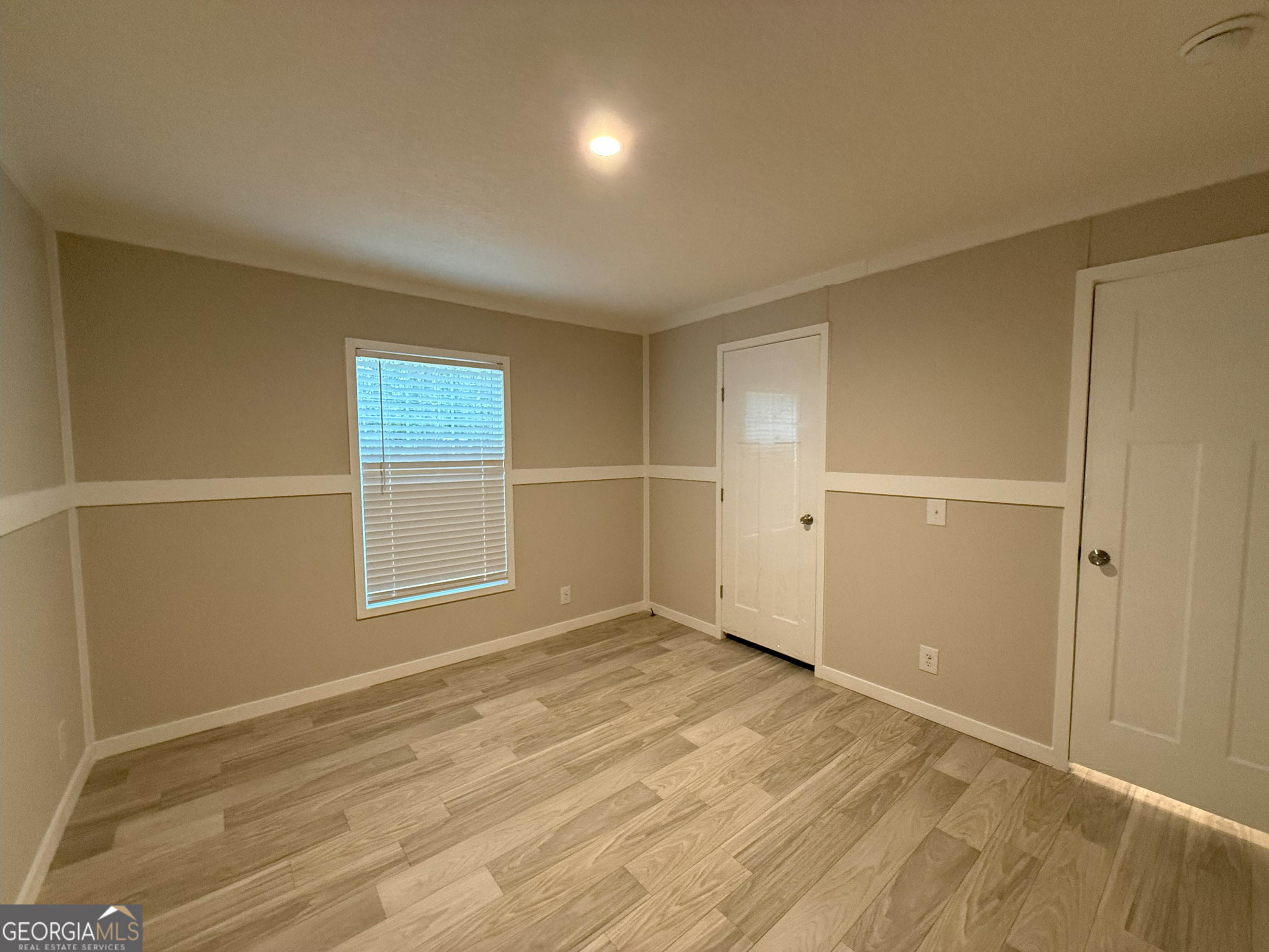 2126 Amberly Road Elberton, GA 30635 - Photo 28 of 68 an empty room with wooden floor and windows