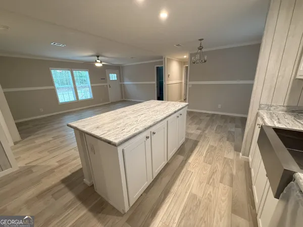 a kitchen with a stove a sink and a microwave