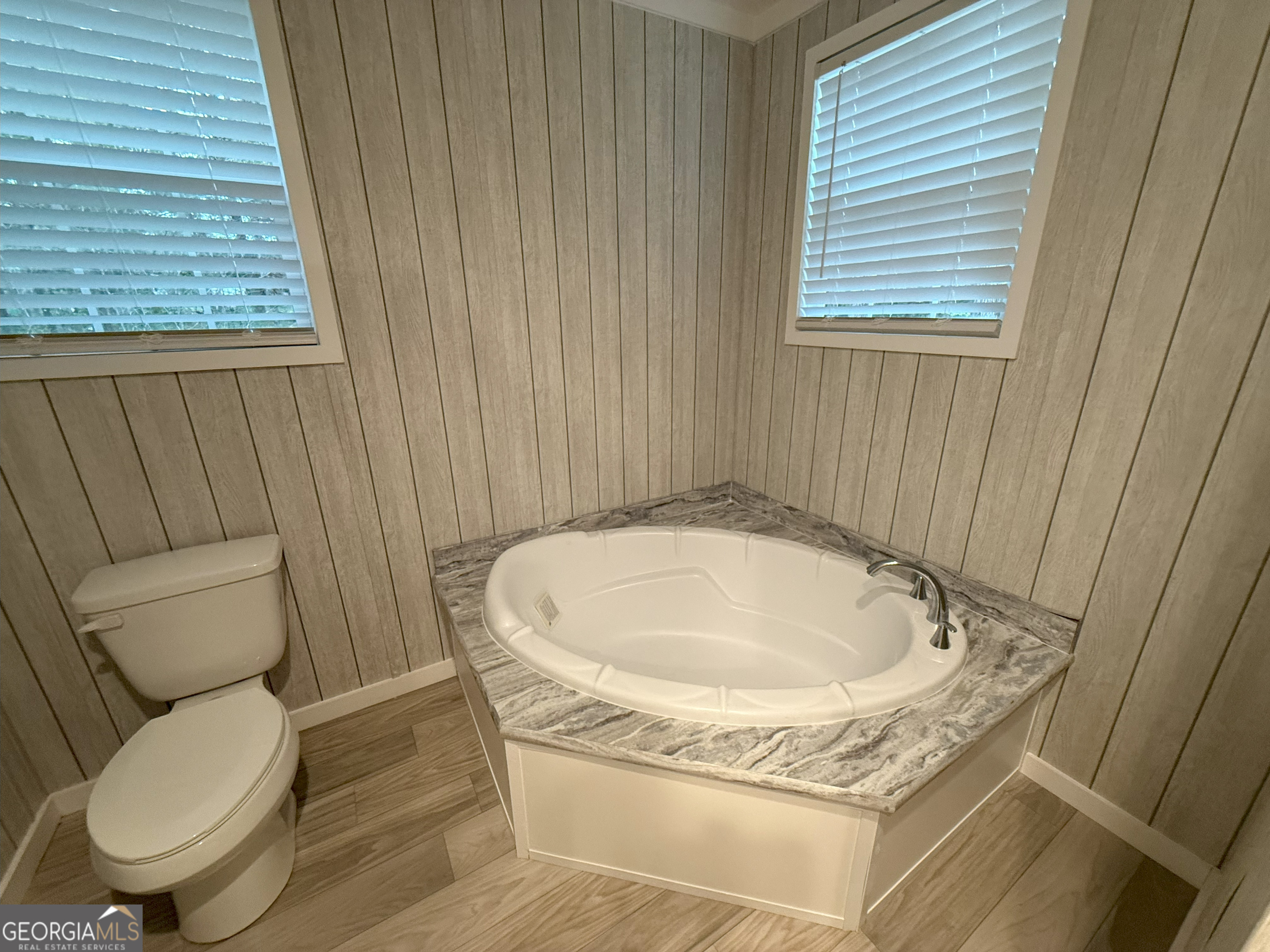 2126 Amberly Road Elberton, GA 30635 - Photo 37 of 68 a bathroom with a granite countertop toilet a sink and a bathtub