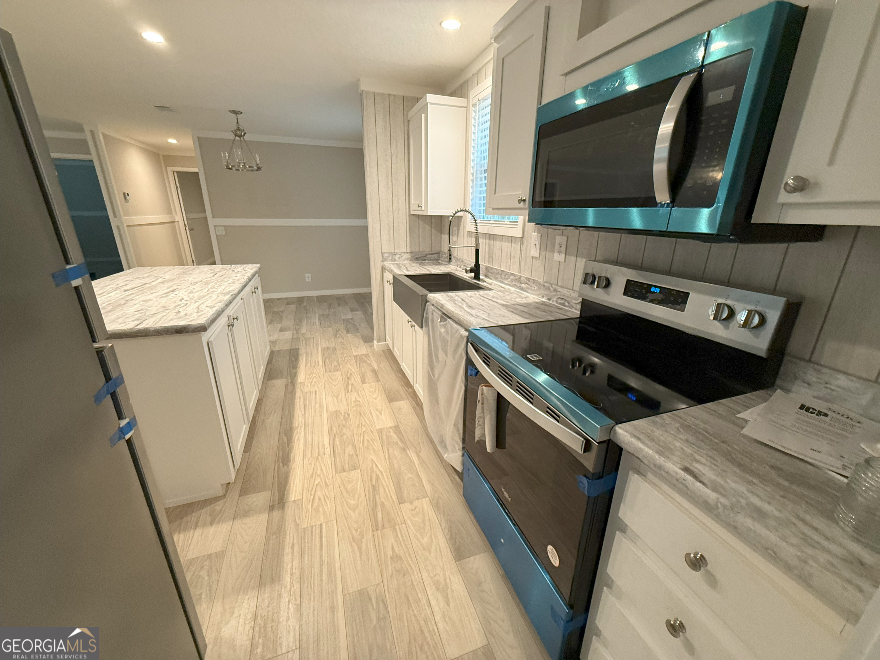 2126 Amberly Road Elberton, GA 30635 - Photo 4 of 68 a kitchen with a stove a sink and a microwave