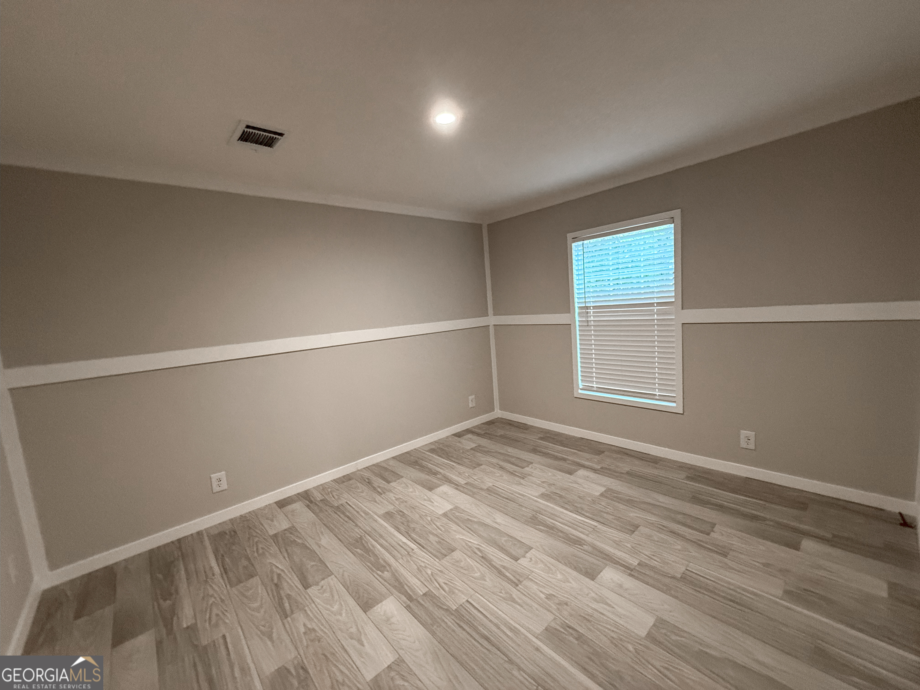 2126 Amberly Road Elberton, GA 30635 - Photo 45 of 68 a view of an empty room with wooden floor and a window