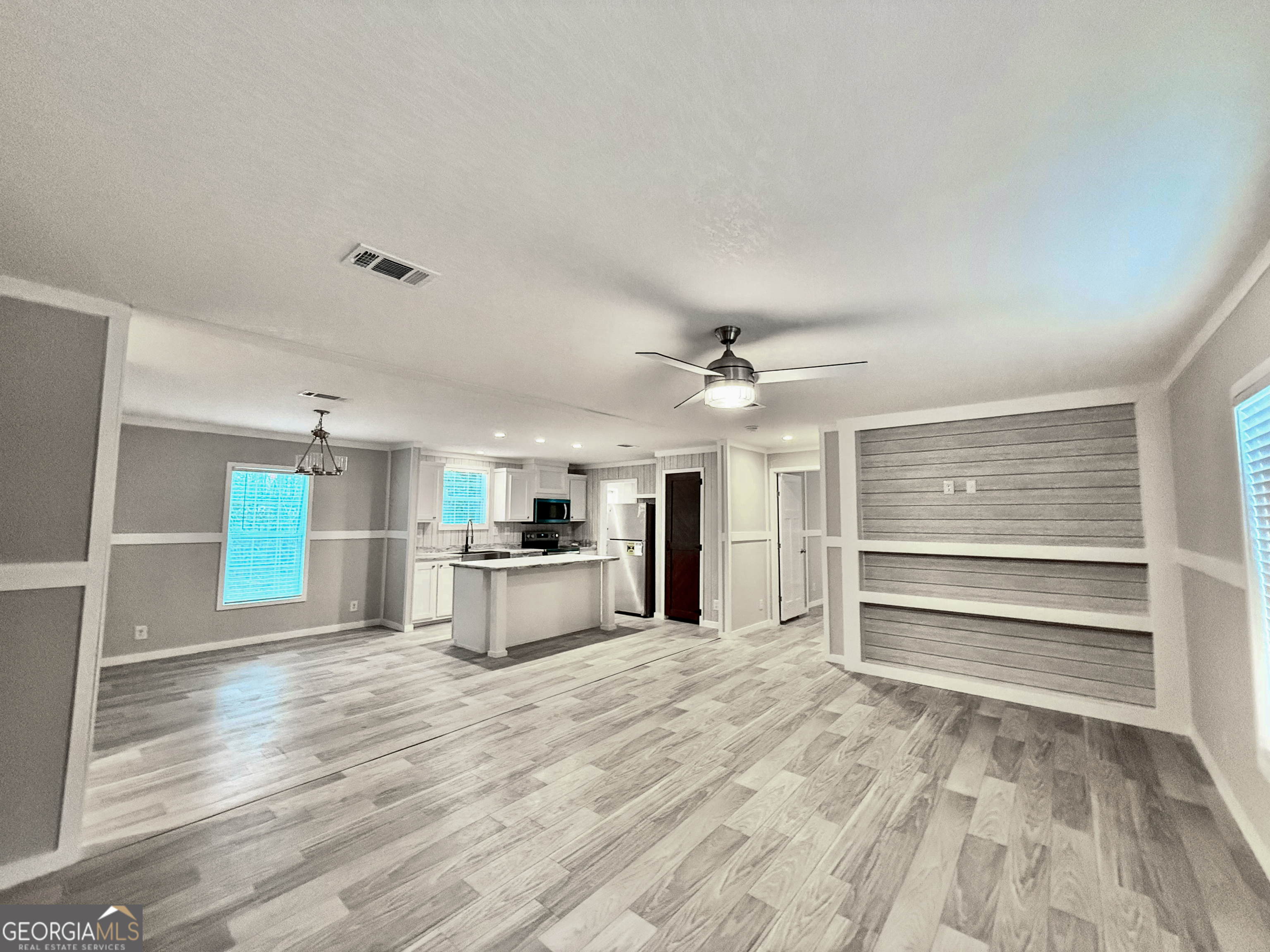 2126 Amberly Road Elberton, GA 30635 - Photo 55 of 68 a large white kitchen with kitchen island a sink stainless steel appliances and cabinets