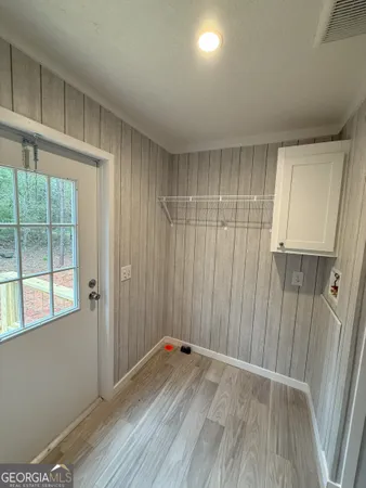 a kitchen with a sink a microwave a refrigerator and wooden floor