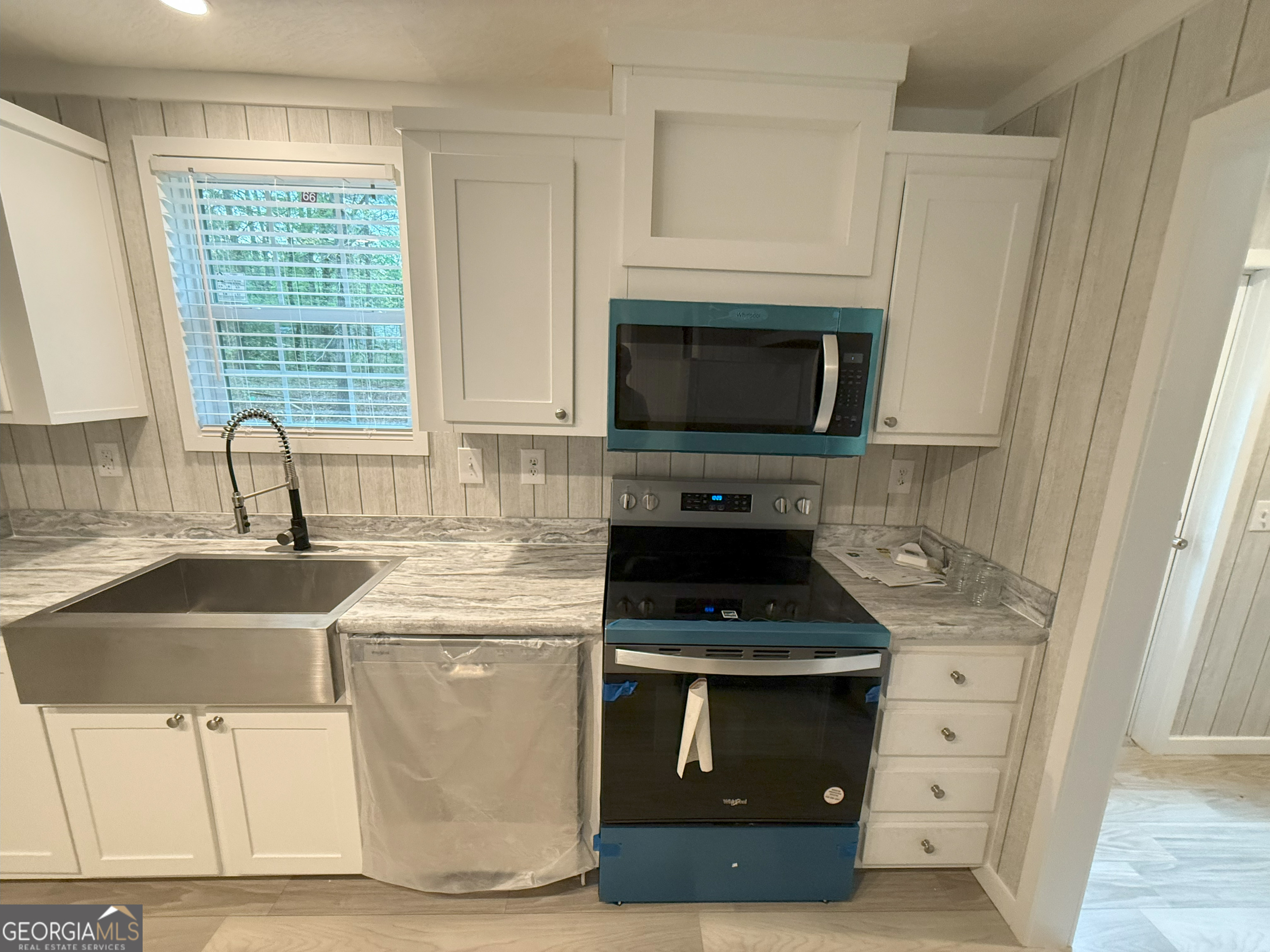 2126 Amberly Road Elberton, GA 30635 - Photo 8 of 68 a kitchen with stainless steel appliances a stove a sink and a microwave