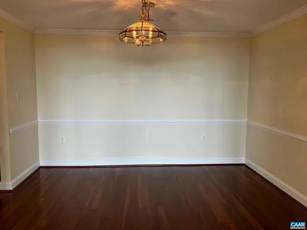 a view of a room with wooden floor and white walls