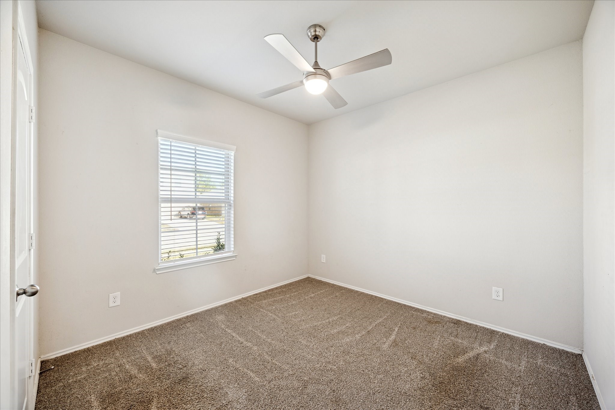 23703 Harrow Field Ln Spring Spring, TX 77373 - Photo 6 of 9 an empty room with windows and ceiling fan
